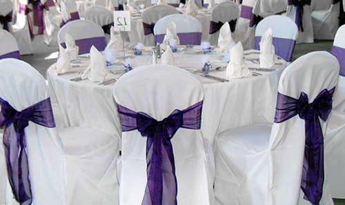 decorative purple sash on white chair covers